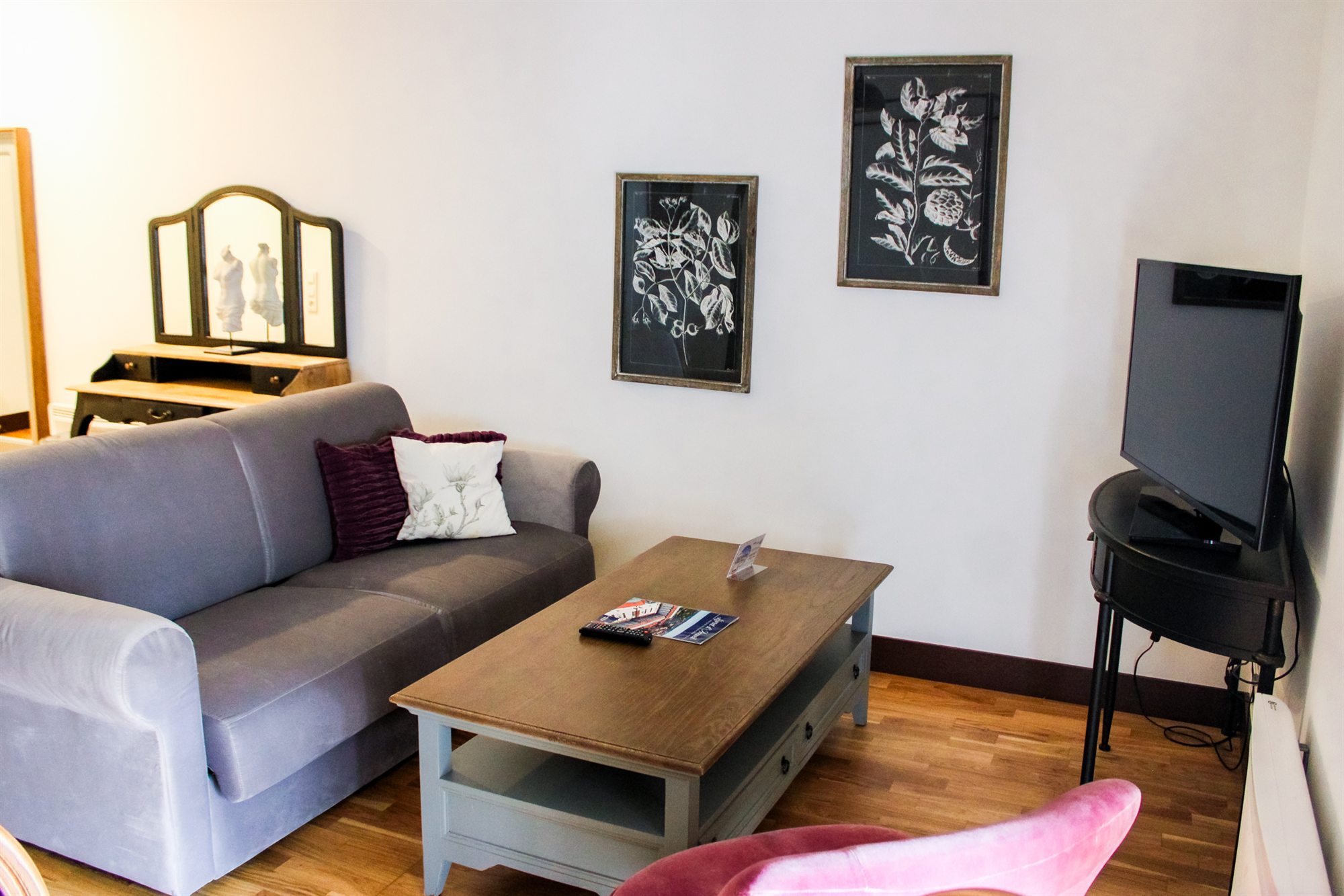 Studio T1 — coin détente avec canapé, table basse et télévision
